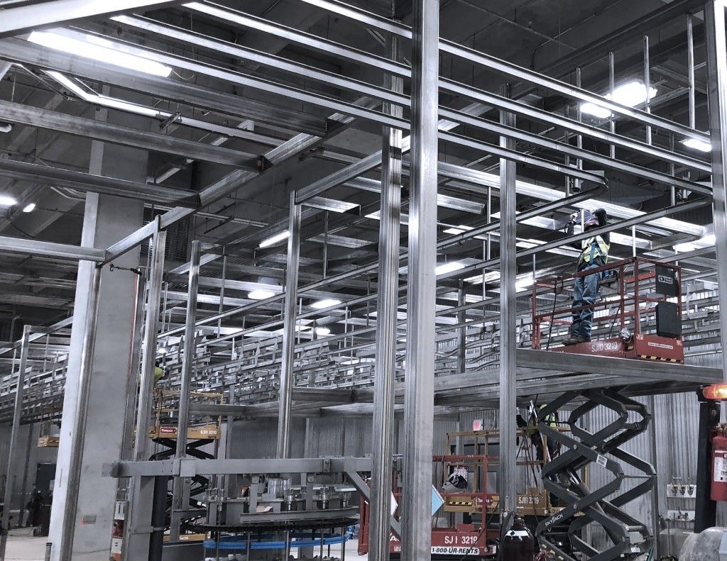ProFab workers reinstalling equipment in a food processing facility