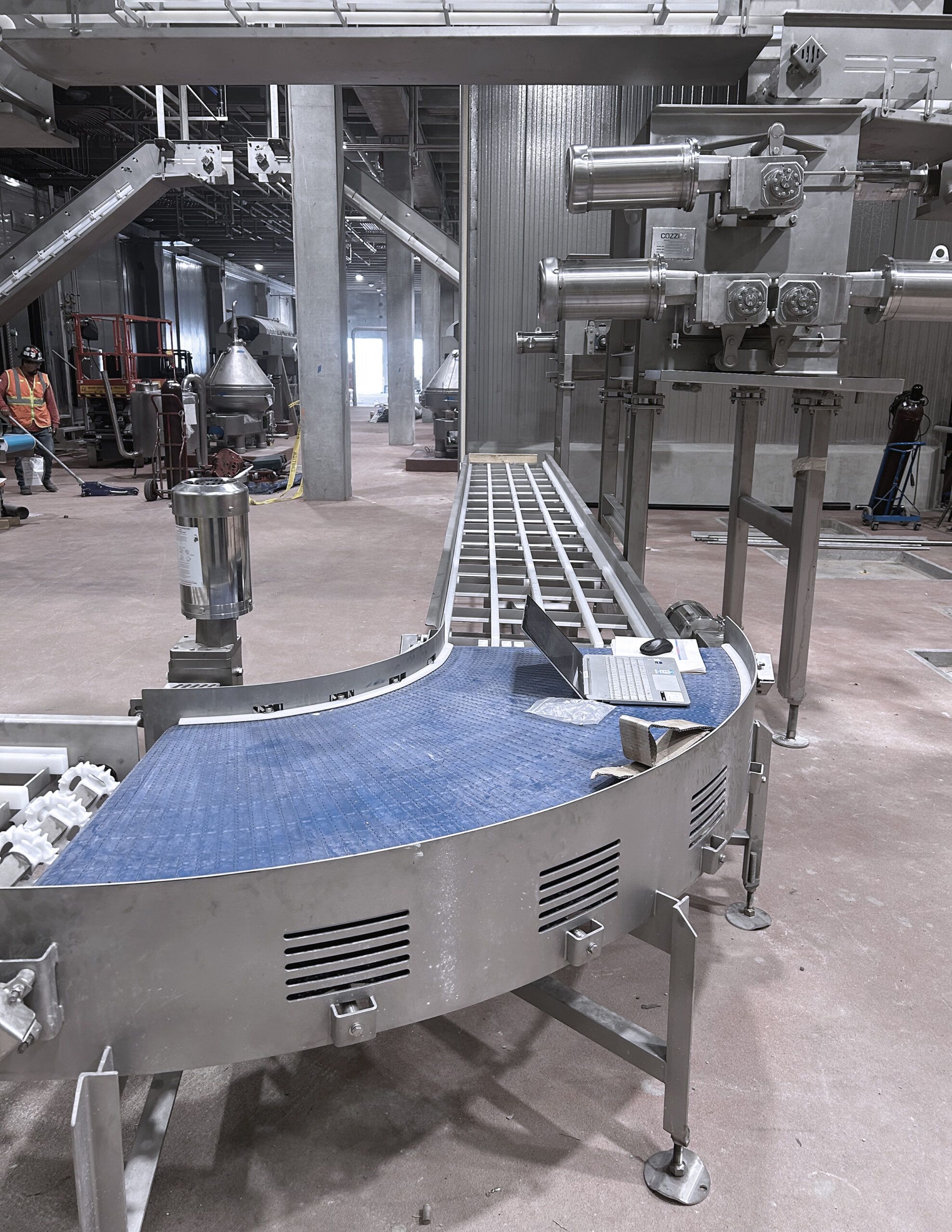 Fabricated conveyor installed in a food processing facility